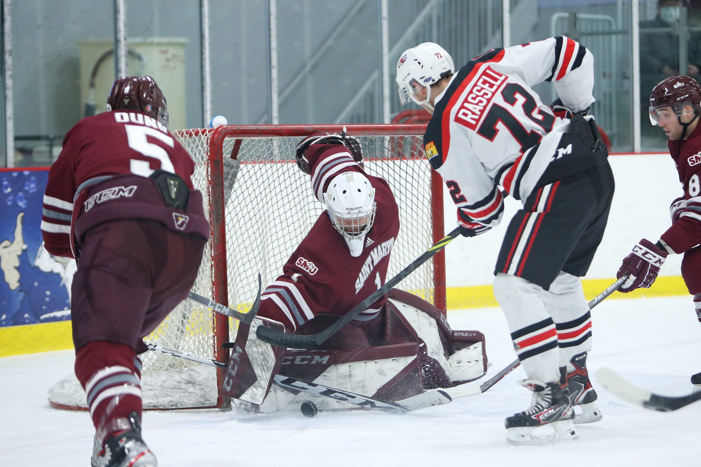 Huskies goaltender Justin Sumarah makes a save on UNB REDS Mark Rassell, one of Sumarah's 47 saves in a thrilling 4-3 win over the top ranked REDS on Saturday, Feb. 26, 2022 at the Dauphinee Centre in Halifax.
