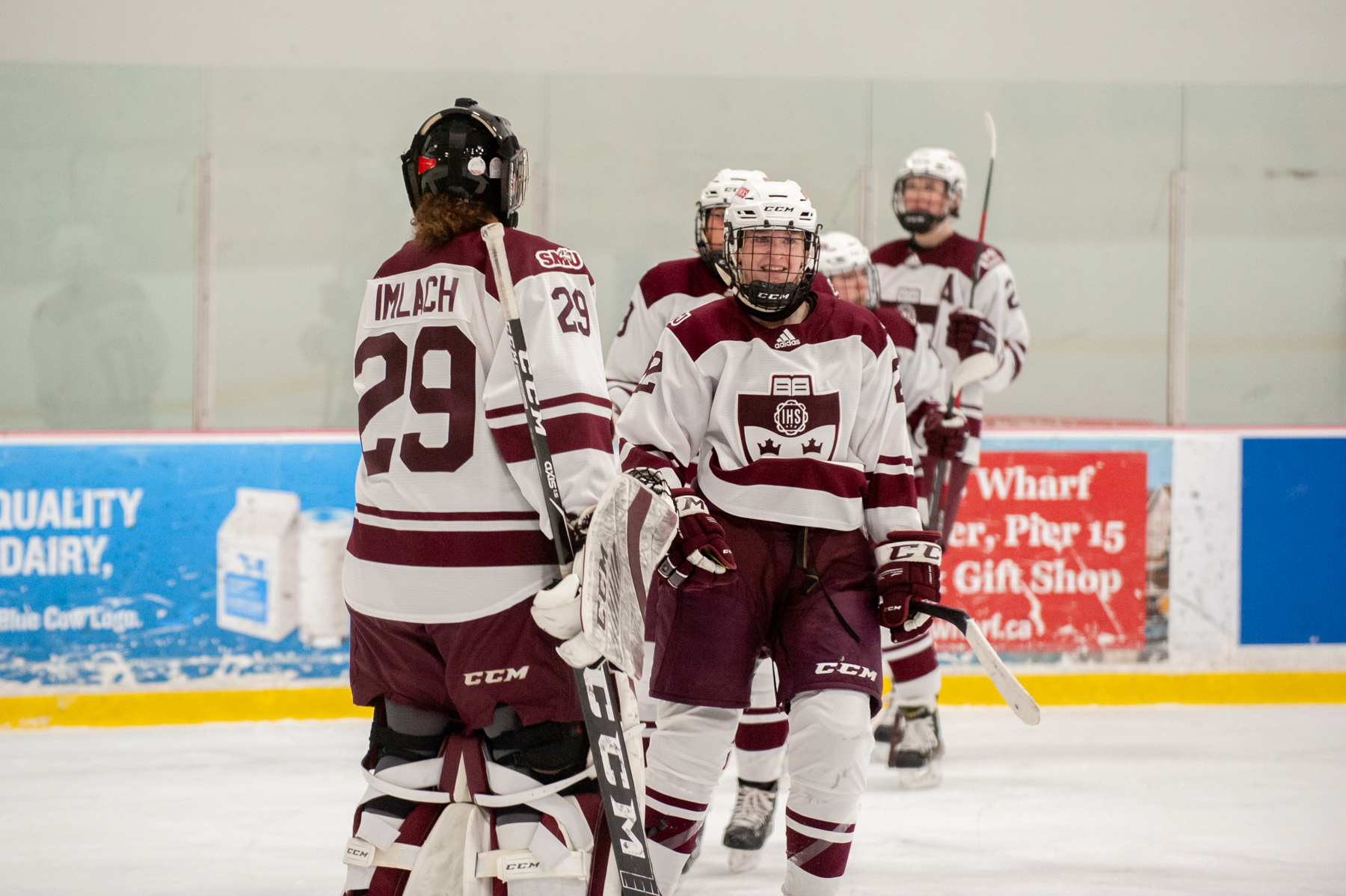 Huskies goaltender Ashley Imlach is congratulated by her teammates after the Huskies 4-2 win over UPEI on Saturday, March 5, 2022.