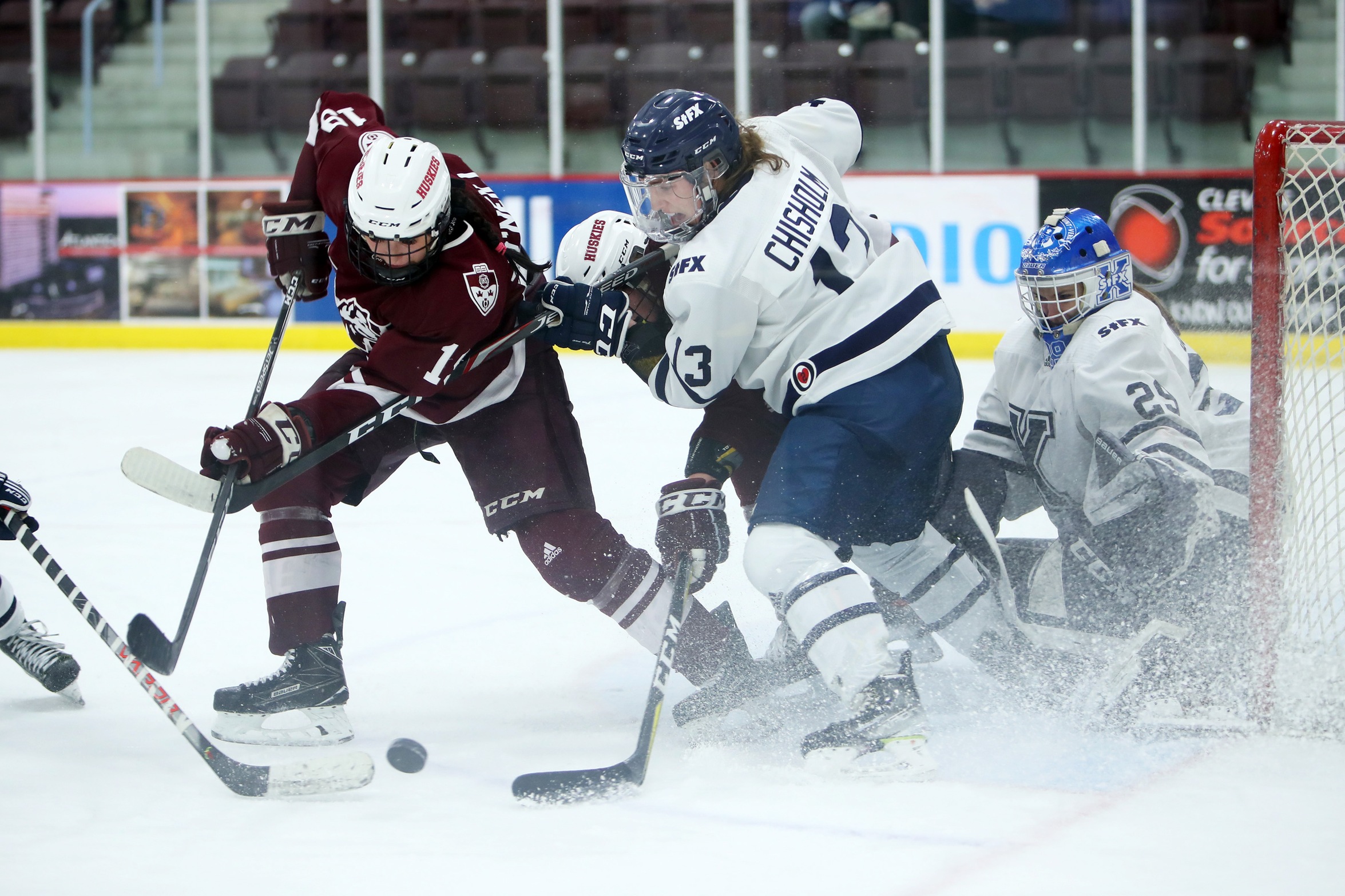 Saint Mary's Huskies forward Aimee O'Neill (#19) battles with St. FX X-Women defenceman Josie Chisholm (#13) during the X-Women come from behind 4-3 victory over the Huskies on Feb. 21, 2022.
