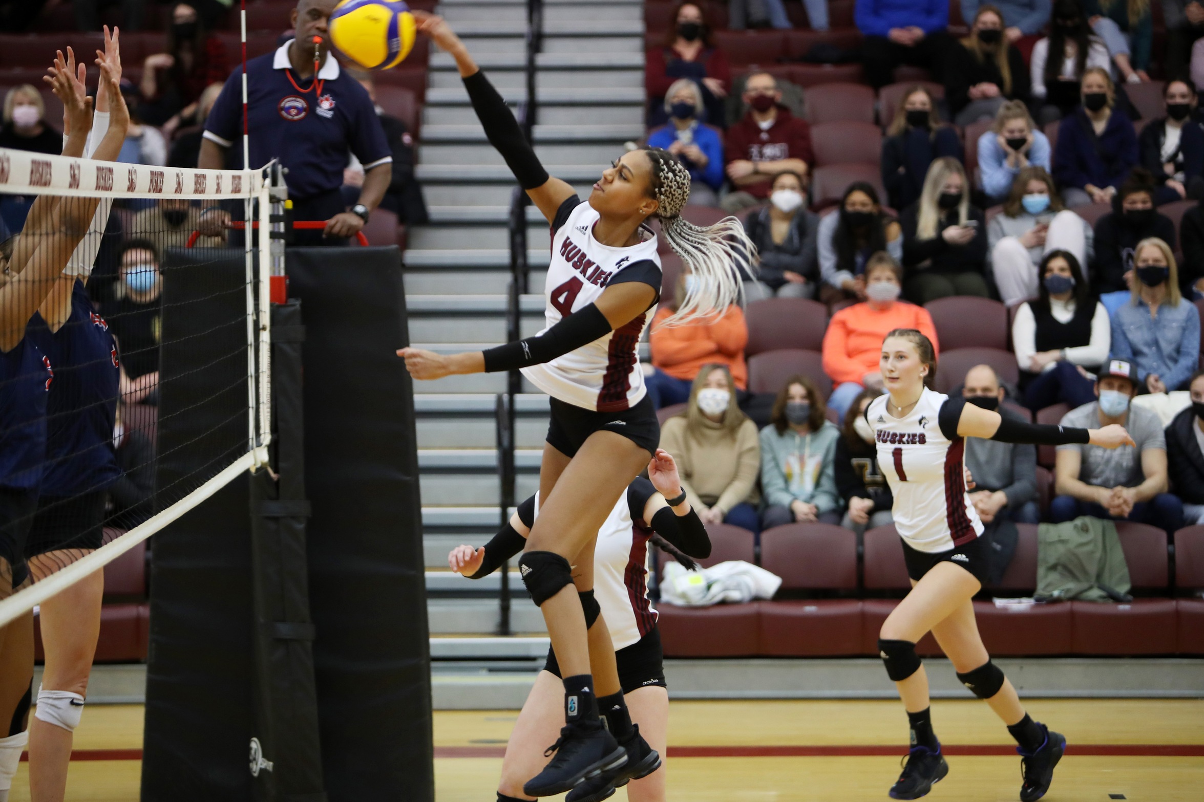 Huskies middle blocker Mariama Syll powers an attack agains the Acadia Axewomen during a 3-2 Axewomen win on Sunday, Feb. 20, 2022.